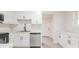 Modern kitchen with white cabinets, stainless steel appliances, granite counters, and gray flooring at 2616 Holton Ave, Charlotte, NC 28208