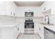 Stylish kitchen features white cabinetry, stainless steel appliances, and granite countertops, offering a clean aesthetic at 2616 Holton Ave, Charlotte, NC 28208