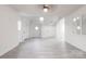 Open living space filled with natural light, featuring modern gray flooring, stylish lighting, and white walls at 2616 Holton Ave, Charlotte, NC 28208