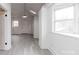 Well-lit living space with gray floors, white walls, and a view of the outdoors through a large window at 2616 Holton Ave, Charlotte, NC 28208