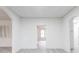 Open-concept living space featuring neutral walls, archways, gray floors, and seamless transitions to other rooms at 2616 Holton Ave, Charlotte, NC 28208