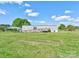View of home featuring a ramp, deck, and carport, nestled in a spacious, grassy yard under a partly cloudy sky at 2923-1 G B Blanton Rd, Shelby, NC 28152