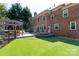 Backyard with a deck, patio, and artificial grass at 3010 Lakewood Edge Dr, Charlotte, NC 28269