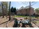 Spacious brick home backyard with firepit seating area, garden and covered hot tub at 3010 Lakewood Edge Dr, Charlotte, NC 28269