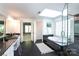 Bright bathroom featuring a glass block window, jacuzzi tub, glass shower and double vanity at 3010 Lakewood Edge Dr, Charlotte, NC 28269