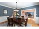 Formal dining room with wainscoting, chandelier, and table set for six guests at 3010 Lakewood Edge Dr, Charlotte, NC 28269
