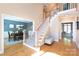 Bright two-story foyer with wood floors, elegant staircase and sight lines into dining room at 3010 Lakewood Edge Dr, Charlotte, NC 28269