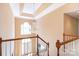 Elegant foyer with a chandelier and a view of the front door from the upper level at 3010 Lakewood Edge Dr, Charlotte, NC 28269