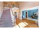 Grand foyer with staircase, hardwood floors, and natural light, leading to a living space at 3010 Lakewood Edge Dr, Charlotte, NC 28269