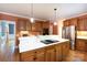 Kitchen island with a cooktop, stainless steel appliances, and white countertops at 3010 Lakewood Edge Dr, Charlotte, NC 28269