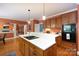 Spacious kitchen with modern appliances, wooden cabinetry, and a view into the living room at 3010 Lakewood Edge Dr, Charlotte, NC 28269