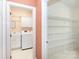 Laundry room with utility sink, washer, dryer, and shelving for additional storage at 3010 Lakewood Edge Dr, Charlotte, NC 28269