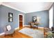 Cozy living room with soft rug, writing desk, and views into the bar area at 3010 Lakewood Edge Dr, Charlotte, NC 28269