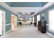 Spacious primary bedroom featuring tray ceiling, fan, and neutral decor at 3010 Lakewood Edge Dr, Charlotte, NC 28269