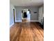 Spacious living room showcasing hardwood floors, arched doorway and natural light at 3507 Rogers St, Charlotte, NC 28208