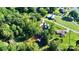 An aerial perspective of a secluded home with a dock, set amongst verdant trees and tranquil waters at 3915 Chevlot Hills Rd, Sherrills Ford, NC 28673