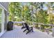 Spacious back deck offering a grill, hammock, and chairs for outdoor relaxation among the trees at 3915 Chevlot Hills Rd, Sherrills Ford, NC 28673
