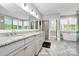 Spacious bathroom boasts a double vanity with granite countertops, modern fixtures, and a luxurious soaking tub at 3915 Chevlot Hills Rd, Sherrills Ford, NC 28673