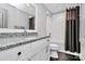 Well-lit bathroom features a granite vanity, a large mirror, and a shower-tub combination with dark accents at 3915 Chevlot Hills Rd, Sherrills Ford, NC 28673