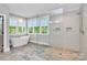 Bright bathroom features a soaking tub under a window and a glass-enclosed shower with tile accents at 3915 Chevlot Hills Rd, Sherrills Ford, NC 28673