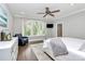 Relaxing primary bedroom with large windows, ceiling fan, hardwood floors, and a serene ambiance at 3915 Chevlot Hills Rd, Sherrills Ford, NC 28673