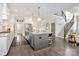 Open kitchen featuring a gray island, modern appliances, and staircase leading to the second floor at 3915 Chevlot Hills Rd, Sherrills Ford, NC 28673