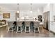 Bright, modern kitchen with a spacious island, white cabinets, stainless steel appliances, and stylish bar stools at 3915 Chevlot Hills Rd, Sherrills Ford, NC 28673