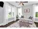 Bright living room featuring large windows, hardwood floors, neutral colors, and a comfortable seating arrangement at 3915 Chevlot Hills Rd, Sherrills Ford, NC 28673