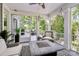 Relaxing screened porch featuring a ceiling fan, comfortable seating, and a stylish fire pit table for outdoor enjoyment at 3915 Chevlot Hills Rd, Sherrills Ford, NC 28673