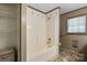 This tiled bathroom offers a shower-tub combo and grab bars for accessibility at 4067 Old Buff Rd, Hickory, NC 28602