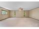 A bright bedroom offers natural light through windows, complemented by a ceiling fan for air circulation at 4067 Old Buff Rd, Hickory, NC 28602