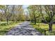 Long, tree-lined driveway leading to the residence with surrounding green landscape at 4067 Old Buff Rd, Hickory, NC 28602