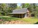 Exterior view of a two-story building with a gabled roof and covered porch, set in a wooded area at 4067 Old Buff Rd, Hickory, NC 28602