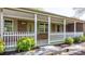 Inviting covered front porch with white railing, decorative columns and brick veneer at 4067 Old Buff Rd, Hickory, NC 28602