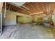 Unfinished garage with concrete block walls and wood beams, offering potential for customization at 4067 Old Buff Rd, Hickory, NC 28602
