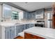Kitchen featuring blue cabinets, a stainless steel refrigerator, and light countertops at 4067 Old Buff Rd, Hickory, NC 28602
