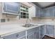 Kitchen with gray cabinets, stainless steel sink, and white countertops at 4067 Old Buff Rd, Hickory, NC 28602