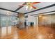 Bright living room featuring hardwood floors, beamed ceiling and views to the kitchen at 4067 Old Buff Rd, Hickory, NC 28602
