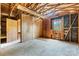 Room with paneled walls, unfinished floors and natural lighting with a door and closet at 4067 Old Buff Rd, Hickory, NC 28602