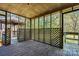 Covered screened porch with wood floors and lattice-style walls, perfect for outdoor enjoyment at 4067 Old Buff Rd, Hickory, NC 28602
