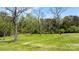 Expansive green yard surrounded by mature trees, offering a peaceful setting at 4067 Old Buff Rd, Hickory, NC 28602