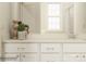 Well-lit bathroom vanity with white cabinets, elegant fixtures, and a large mirror at 4115 Camden Glen Rd, Lancaster, SC 29720