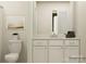 Well-lit bathroom with white cabinets, a sleek mirror, a modern toilet, and neutral paint at 4115 Camden Glen Rd, Lancaster, SC 29720
