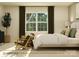 Serene bedroom with a large window, seating, plush bed and olive-green decorative pillows at 4115 Camden Glen Rd, Lancaster, SC 29720