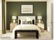 Cozy bedroom with a queen-size bed, stylish bedside tables, and a tranquil olive green accent wall at 4115 Camden Glen Rd, Lancaster, SC 29720