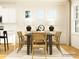 Cozy dining room with white cabinets, wooden furniture, large windows, and hardwood floors at 4115 Camden Glen Rd, Lancaster, SC 29720