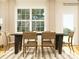 Elegant dining room featuring a large window, stylish chairs, a wooden table, and neutral decor at 4115 Camden Glen Rd, Lancaster, SC 29720