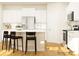Bright kitchen featuring white cabinets, stainless steel appliances, an island with bar stools, and hardwood floors at 4115 Camden Glen Rd, Lancaster, SC 29720