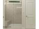 Modern walk-in shower with glass doors, tiled walls, and a built-in bench for comfort at 4115 Camden Glen Rd, Lancaster, SC 29720