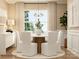 Neutral dining room with a white table, upholstered chairs, modern lighting, and large windows at 4194 Skyboat Cir, Fort Mill, SC 29715